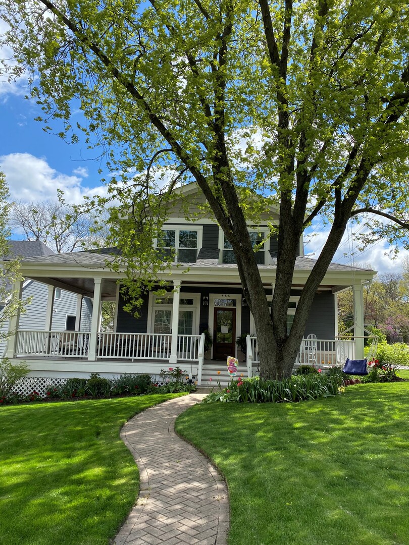 a front view of a house with a garden