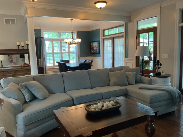 a living room with furniture and a dining table