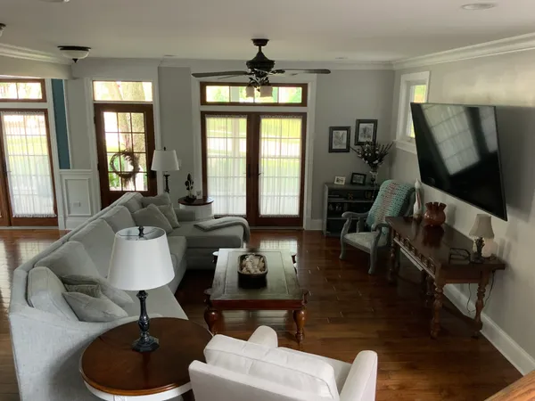 a living room with furniture fireplace and a large window