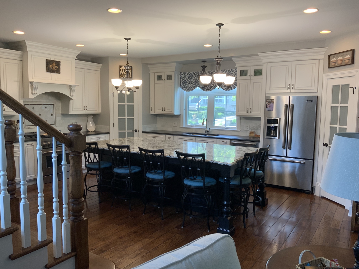 488 South Columbia Street Naperville, IL 60540 - Photo 7 of 14 a kitchen with stainless steel appliances granite countertop a refrigerator a stove a sink dishwasher a dining table and chairs with wooden floor