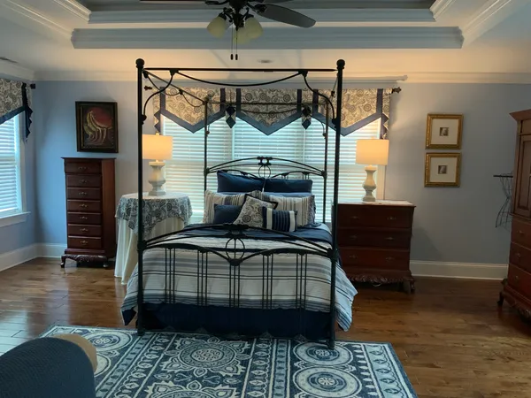 a bedroom with a bed a desk and chair