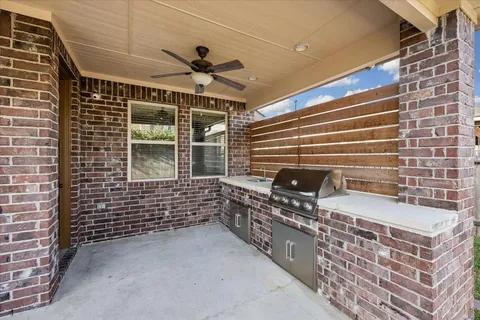 a view of a kitchen with wooden floor and a hallway