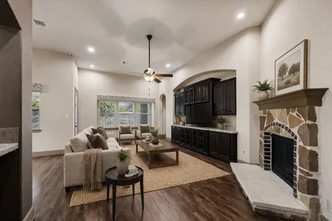 a dining room with furniture a chandelier and wooden floor