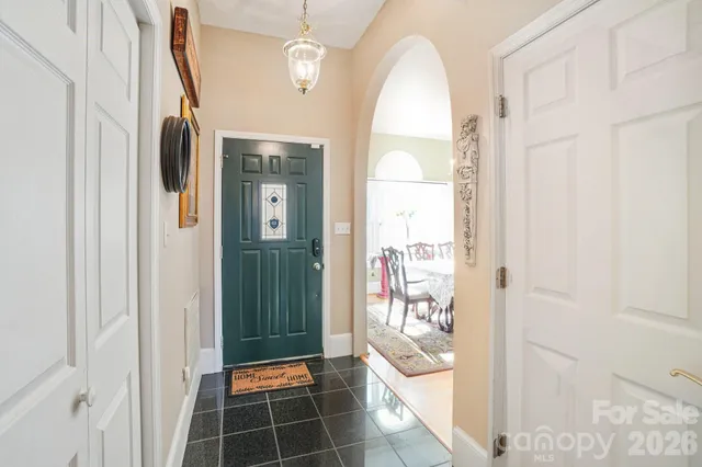 a view of a hallway with wooden floor and a livingroom