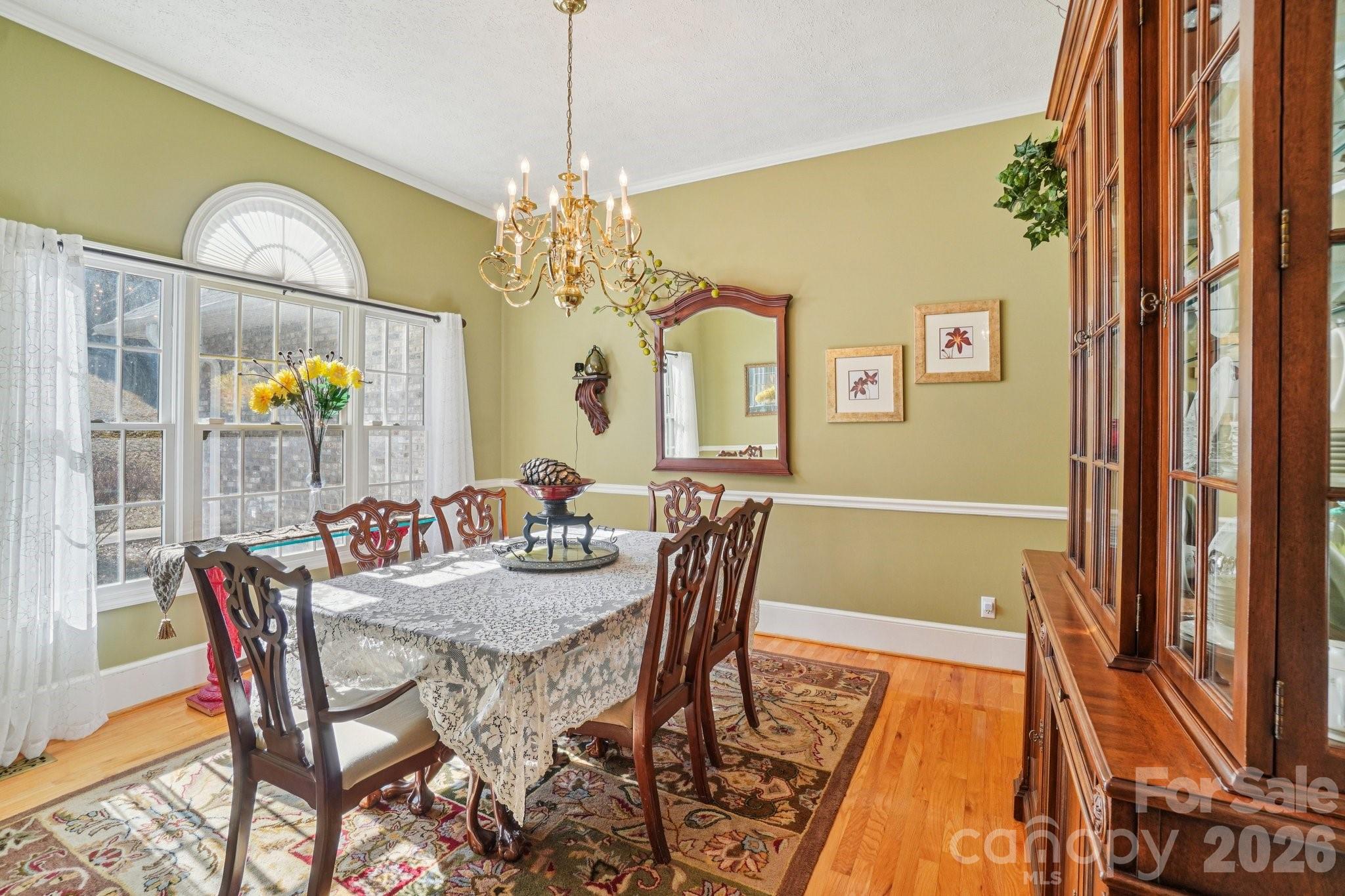 4634 Harbor View Terrace Morganton, NC 28655 - Photo 15 of 39 a view of a dining room with furniture a chandelier and wooden floor