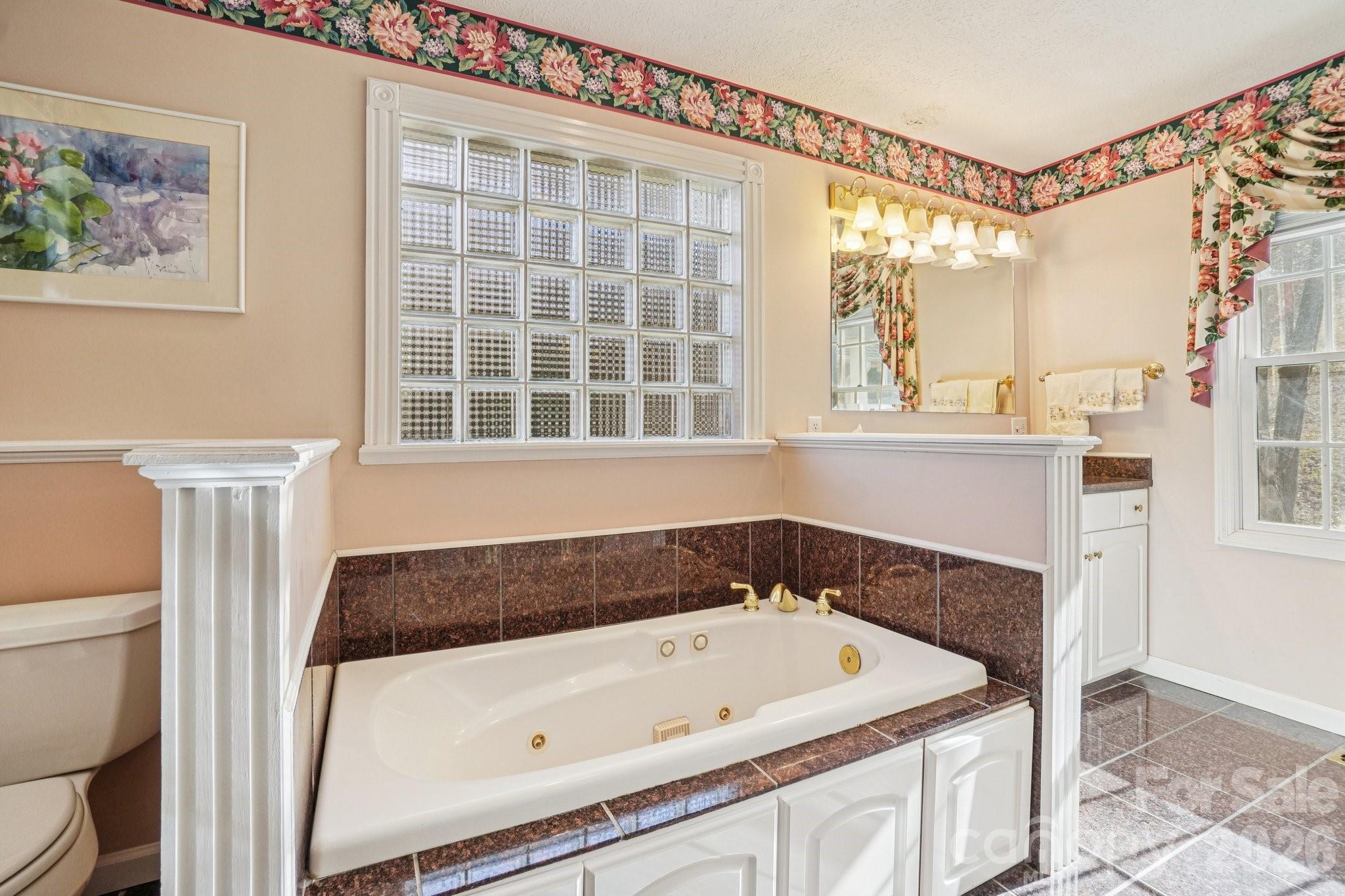 4634 Harbor View Terrace Morganton, NC 28655 - Photo 17 of 39 a bathroom with a tub a sink and a window