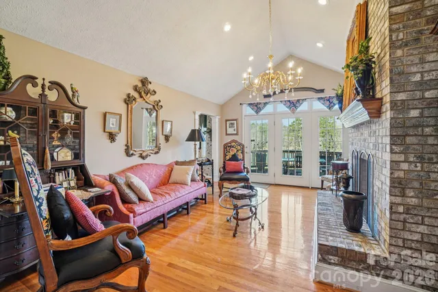 a living room with fireplace furniture and a chandelier
