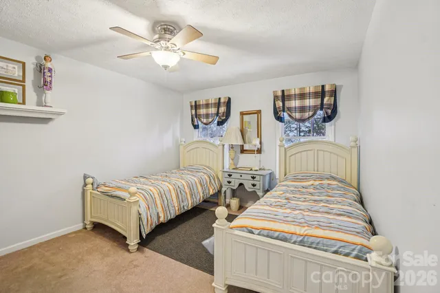 a bedroom with two beds and painting on the wall