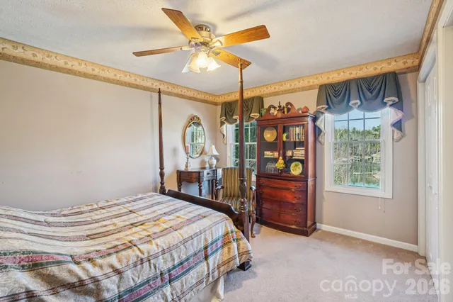 a bedroom with a bed window and a ceiling fan