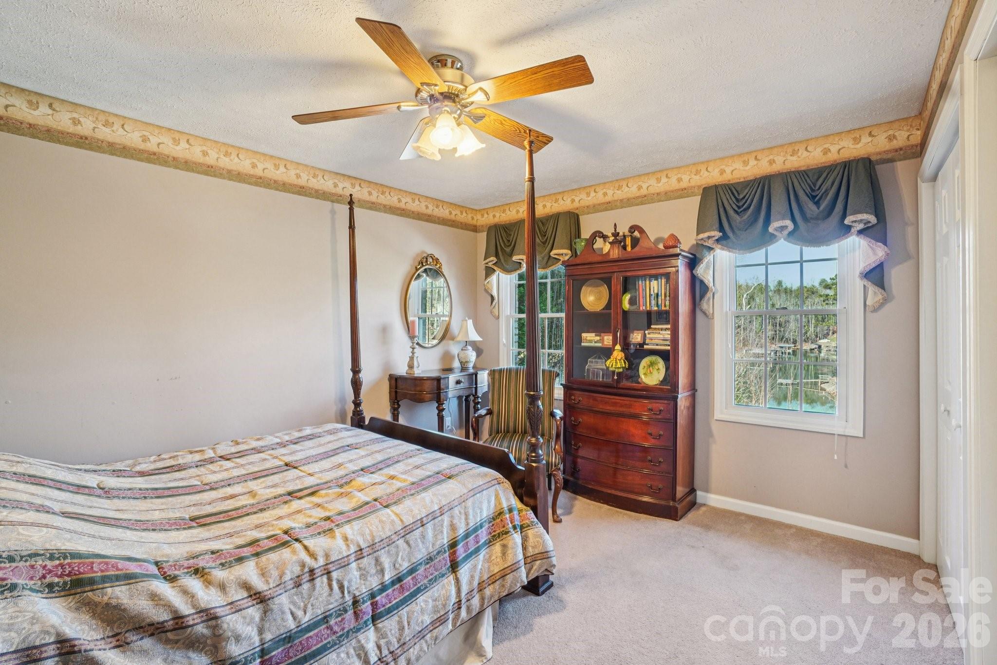 4634 Harbor View Terrace Morganton, NC 28655 - Photo 28 of 39 a bedroom with a bed window and a ceiling fan