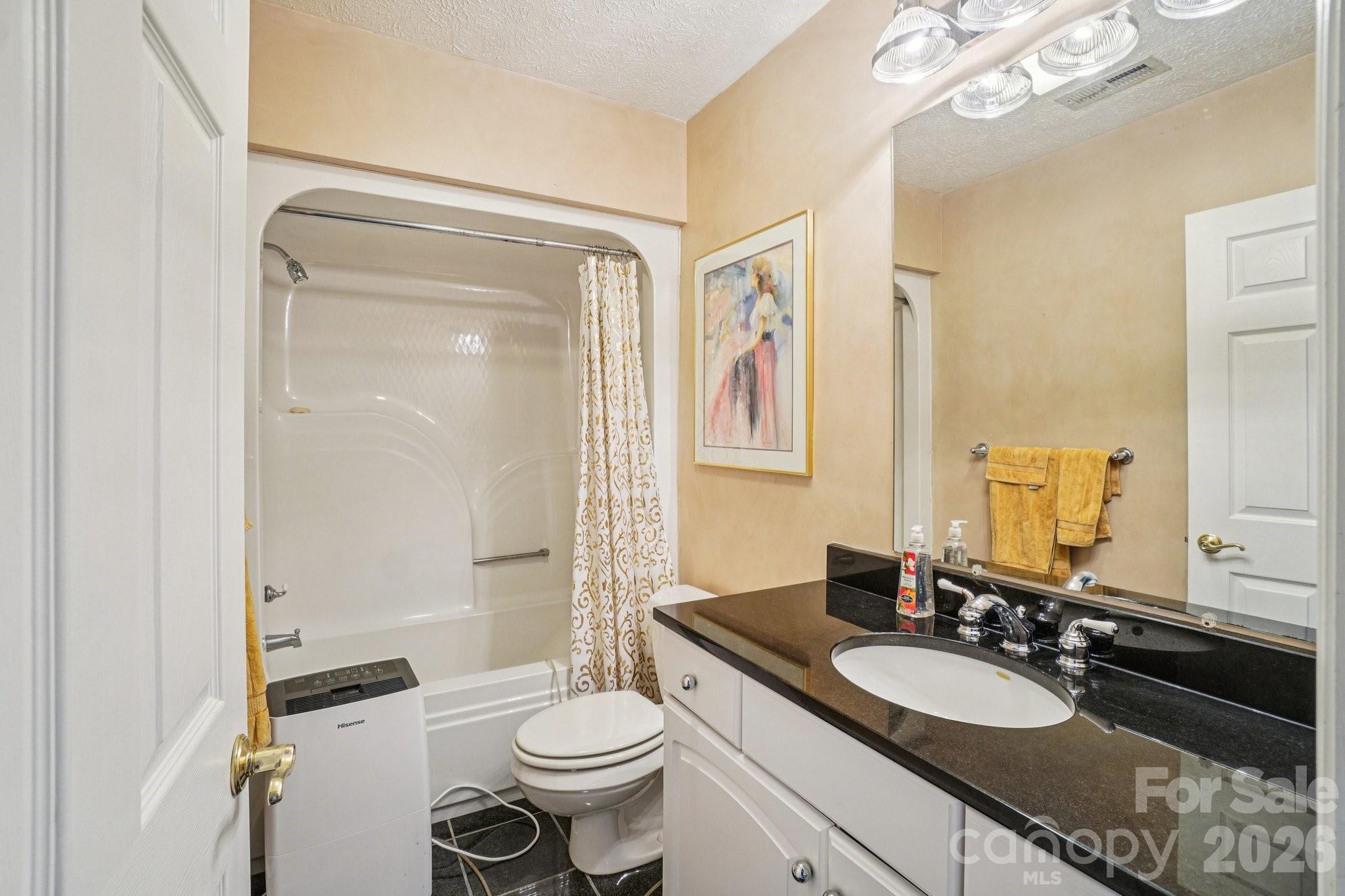 4634 Harbor View Terrace Morganton, NC 28655 - Photo 33 of 39 a bathroom with a granite countertop sink toilet mirror and a shower