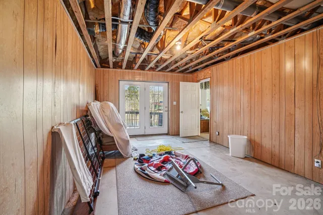 a bedroom with furniture and a large window