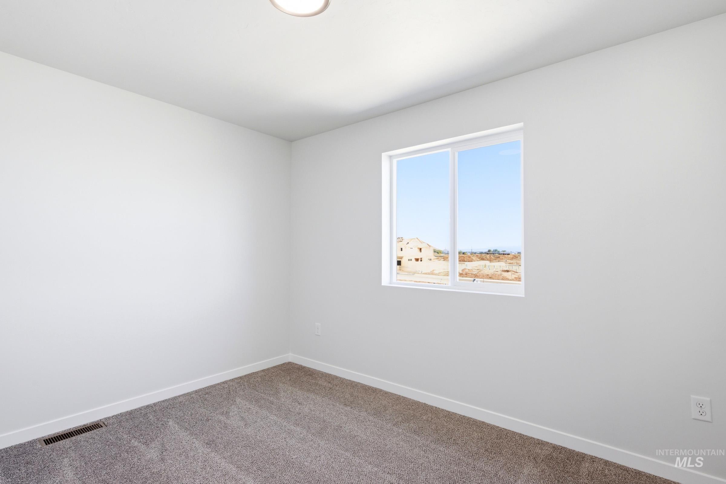10800 Rutland Street Caldwell, ID 83605 - Photo 13 of 21 Neutral-toned room featuring a single window, recessed ceiling lighting, and light grey carpet flooring