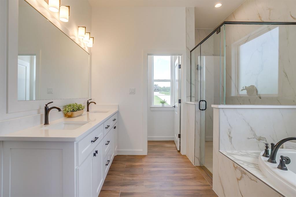 9012 Valley Oak Court Springtown, TX 76082 - Photo 30 of 40 a bathroom with a double vanity sink and mirror