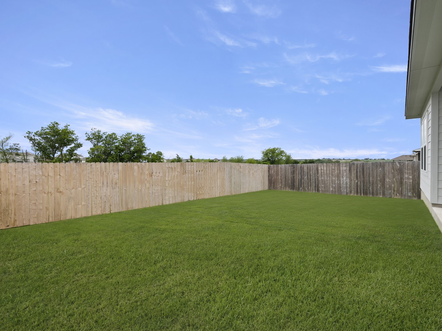 513 Yellow Ribbon Trail Jarrell, TX 76537 - Photo 17 of 23 A spacious, verdant yard enclosed by wood fencing provides a private outdoor retreat.