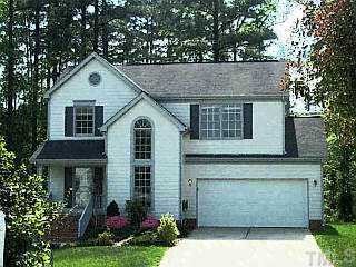 7701 Hollyheight Lane Raleigh, NC 27615 - Photo 1 of 1 a front view of a house with a yard and garage