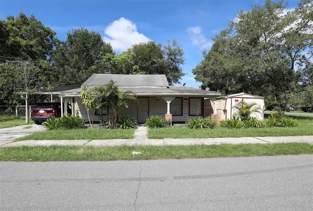 a front view of a house with a yard and a garage
