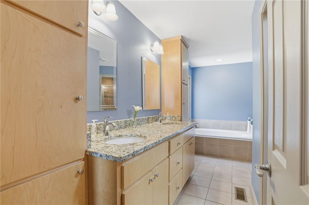 3326 Monument Road Jasper, GA 30143 - Photo 18 of 49 a bathroom with a granite countertop sink and a bathtub