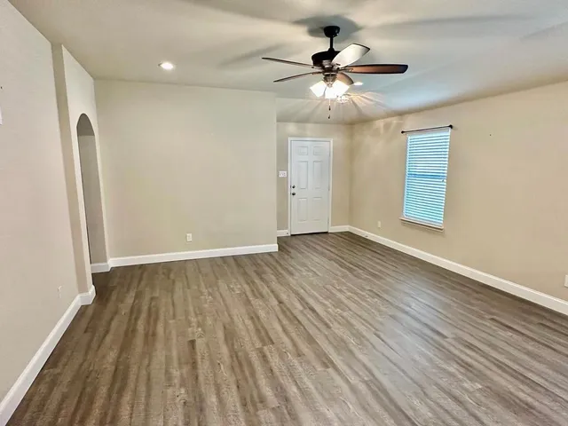 wooden floor in an empty room with a window