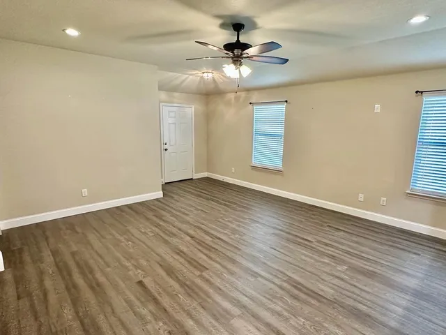 wooden floor in an empty room with a window