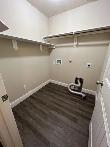 a room with a wooden floor and a sink