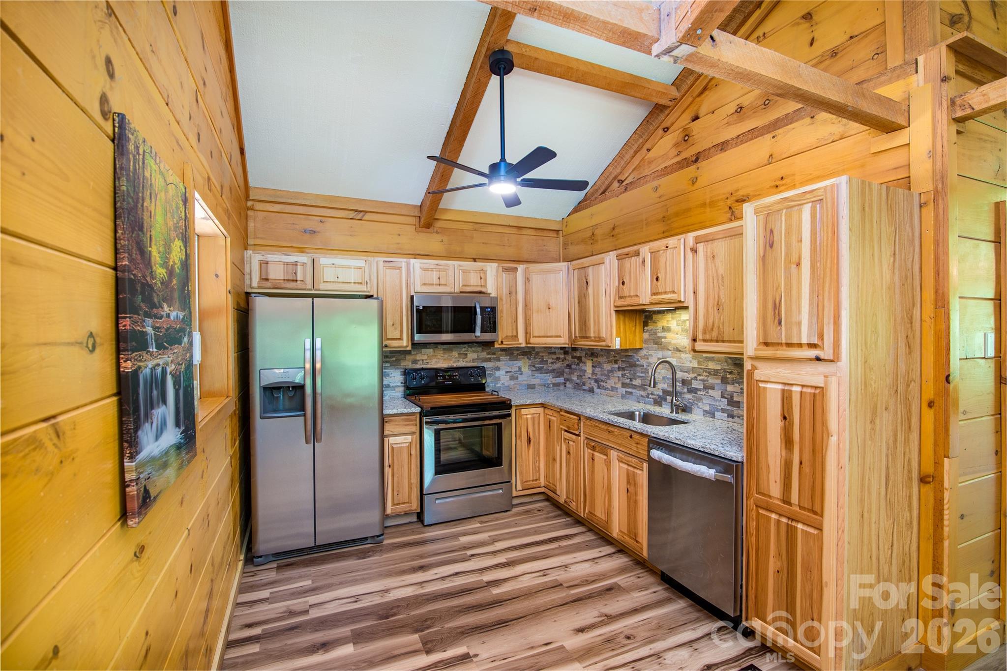 298 Timbuktu Road Sylva, NC 28779 - Photo 5 of 24 a kitchen with stainless steel appliances granite countertop a refrigerator and a stove