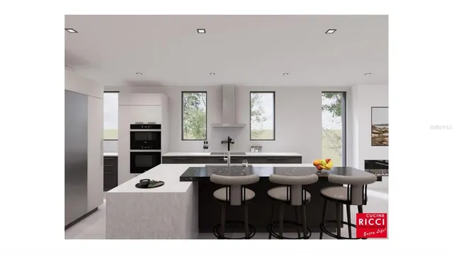 a kitchen with stainless steel appliances kitchen island granite countertop a sink and cabinets