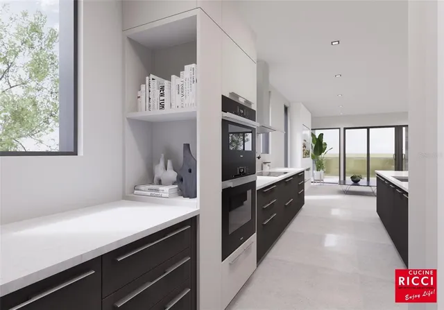 a large white kitchen with a large window