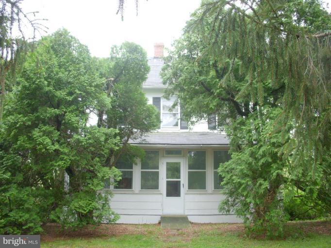 441 Fairhaven Road Tracys Landing, MD 20779 - Photo 3 of 4 a view of a white house with large windows and a small yard