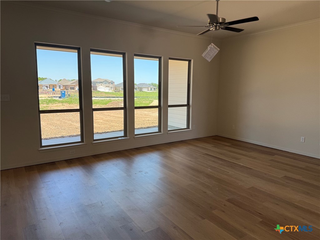7110 Touchstone Drive Temple, TX 76502 - Photo 5 of 9 an empty room with wooden floor fan and windows