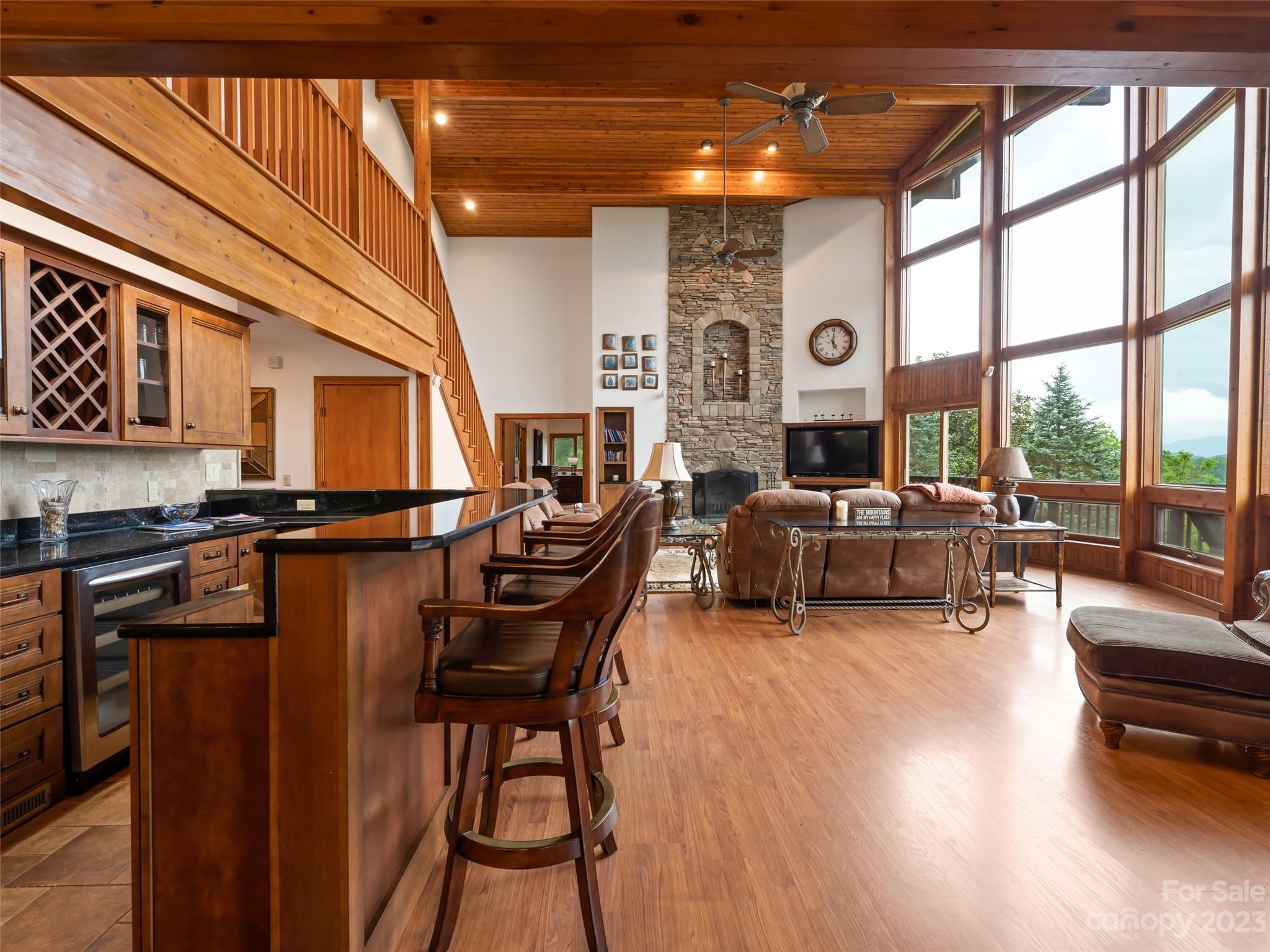 323 Lucky Lane Clyde, NC 28721 - Photo 21 of 48 a living room with furniture a large window and wooden floors