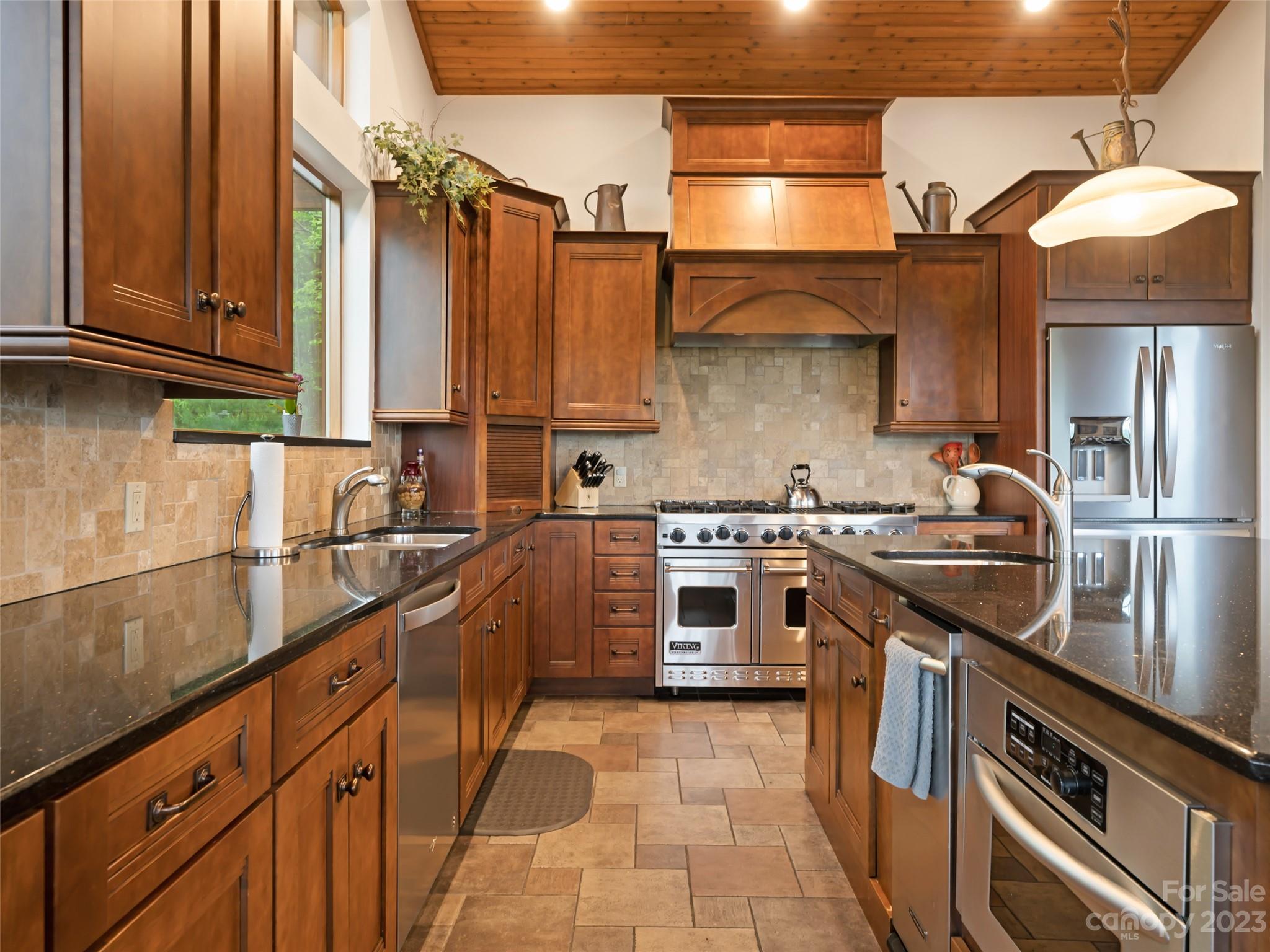 323 Lucky Lane Clyde, NC 28721 - Photo 25 of 48 a kitchen with stainless steel appliances granite countertop a stove a sink and a microwave