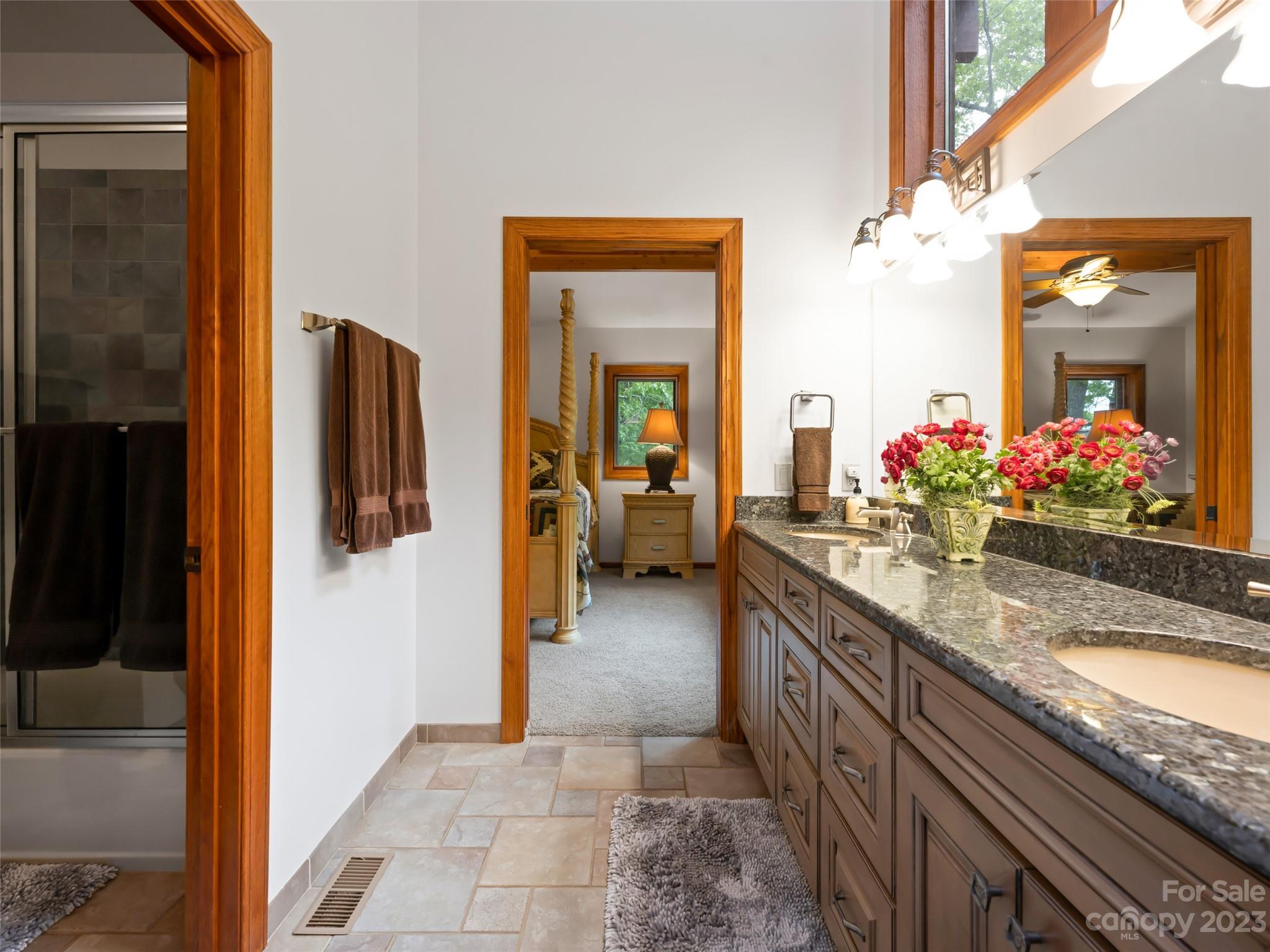 323 Lucky Lane Clyde, NC 28721 - Photo 33 of 48 a bathroom with a granite countertop sink and a mirror