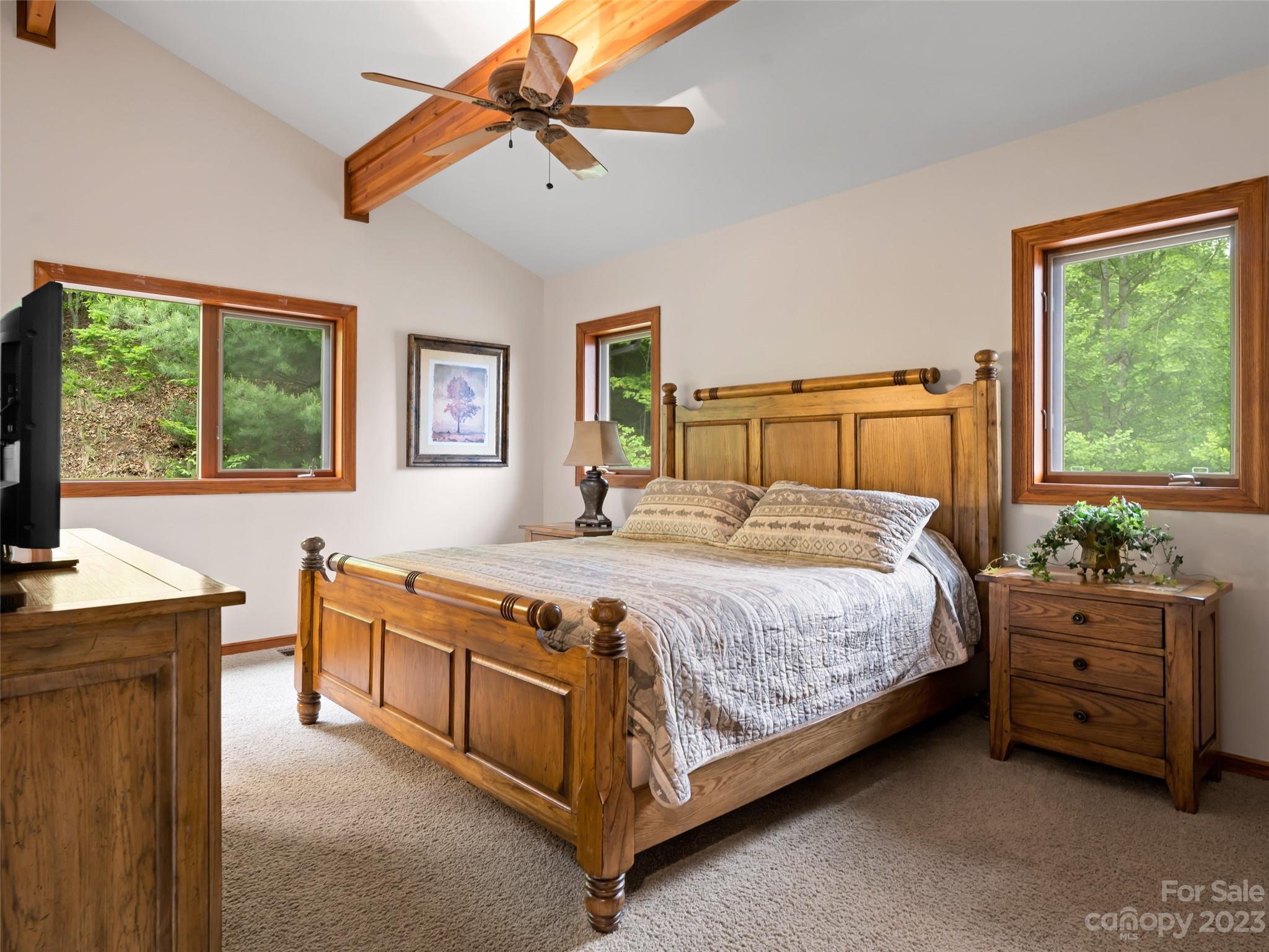 323 Lucky Lane Clyde, NC 28721 - Photo 34 of 48 a bedroom with a bed and a chandelier