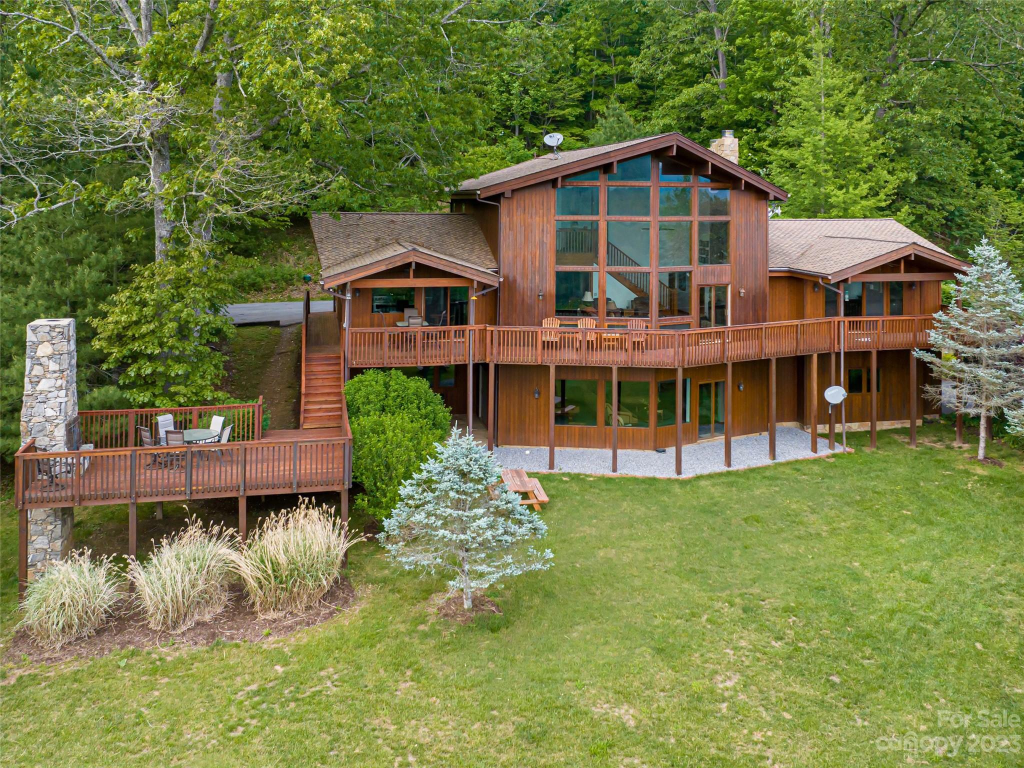 323 Lucky Lane Clyde, NC 28721 - Photo 46 of 48 a front view of a house with a yard table and chairs