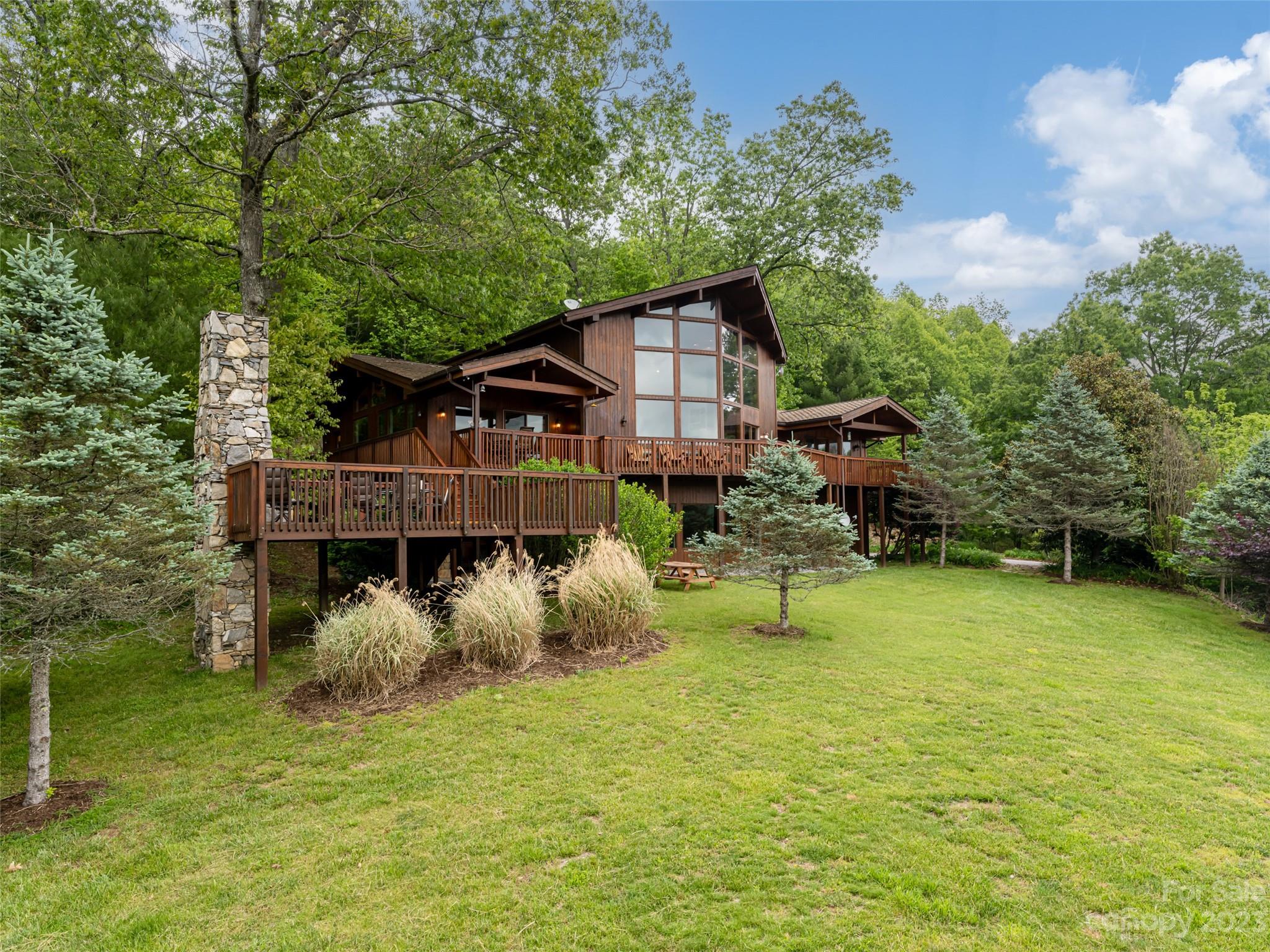 323 Lucky Lane Clyde, NC 28721 - Photo 10 of 48 a view of a house with a yard balcony and sitting area