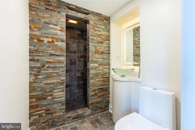 a bathroom with a toilet and a shower