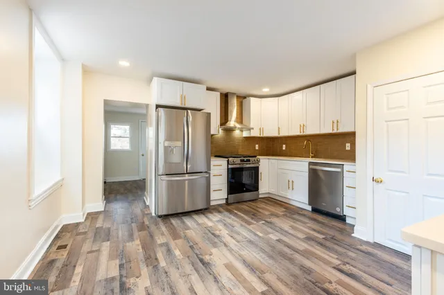 a kitchen with a refrigerator sink and cabinets