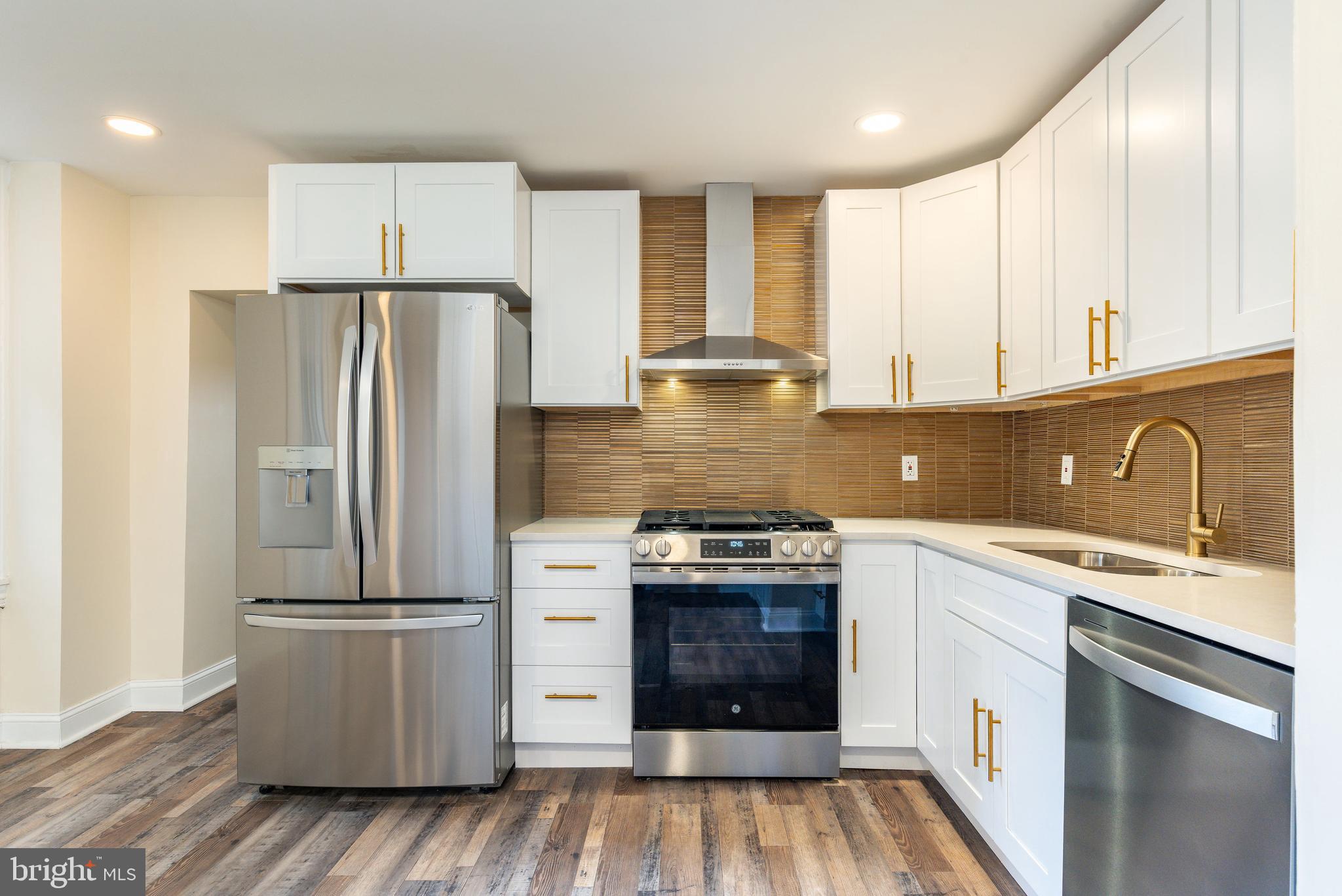 4664 Canton Street Philadelphia, PA 19127 - Photo 6 of 32 a kitchen with a refrigerator sink and wooden cabinets
