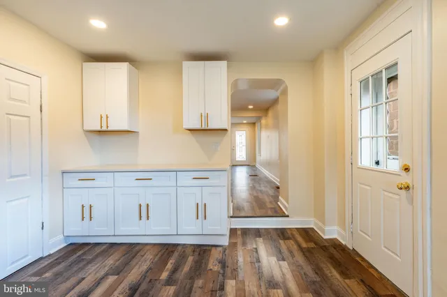 a view of wooden floor and cabinets in a kitchen