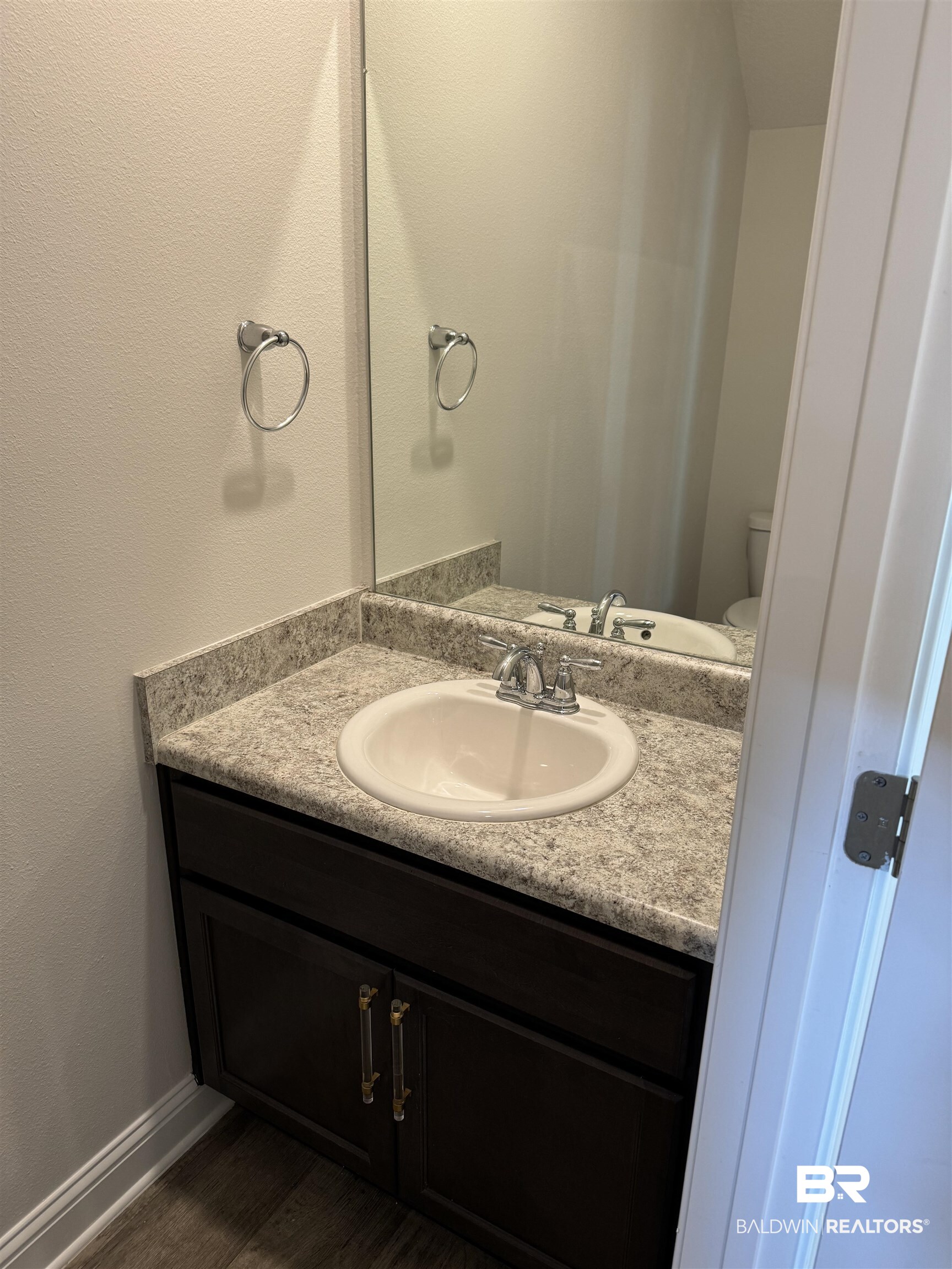 25806 Pollard Road, Unit 42 Daphne, AL 36526 - Photo 8 of 21 Bathroom with vanity, hardwood / wood-style floors, and toilet