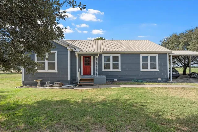 a view of a house with a yard porch and sitting area