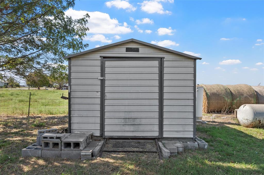 143 Crawford Mount Calm, TX 76673 - Photo 15 of 19 a front view of a house with garden