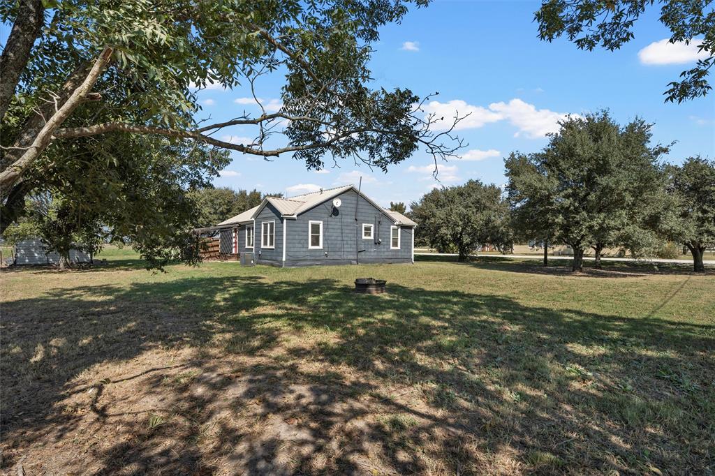 143 Crawford Mount Calm, TX 76673 - Photo 16 of 19 a front view of a house with garden