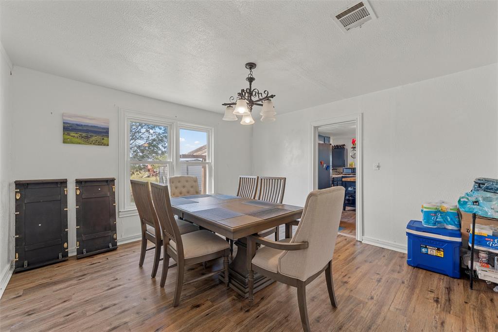 143 Crawford Mount Calm, TX 76673 - Photo 4 of 19 a view of a dining room with furniture and wooden floor