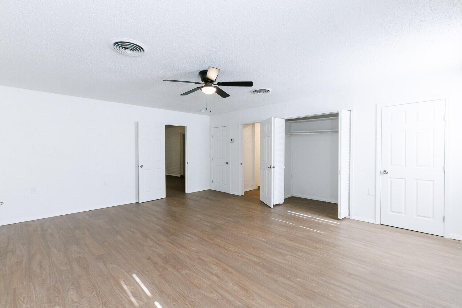 5517 16th Place Lubbock, TX 79416 - Photo 11 of 23 a view of an empty room with a ceiling fan