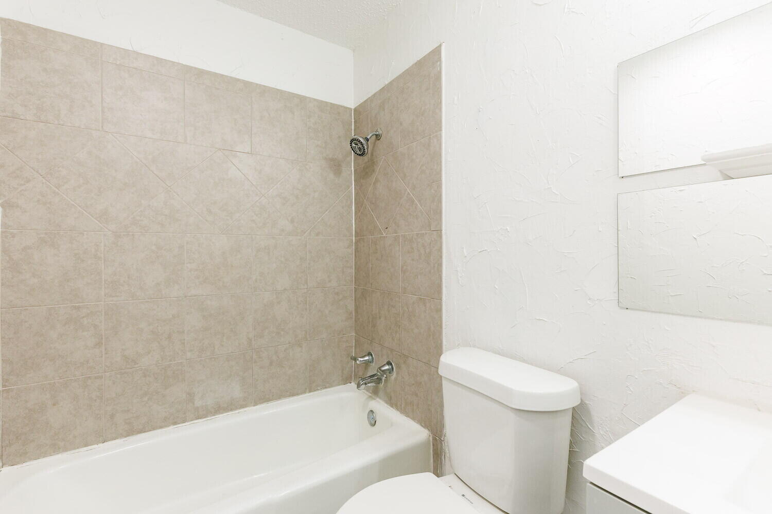 5517 16th Place Lubbock, TX 79416 - Photo 12 of 23 a bathroom with a toilet and a bathtub