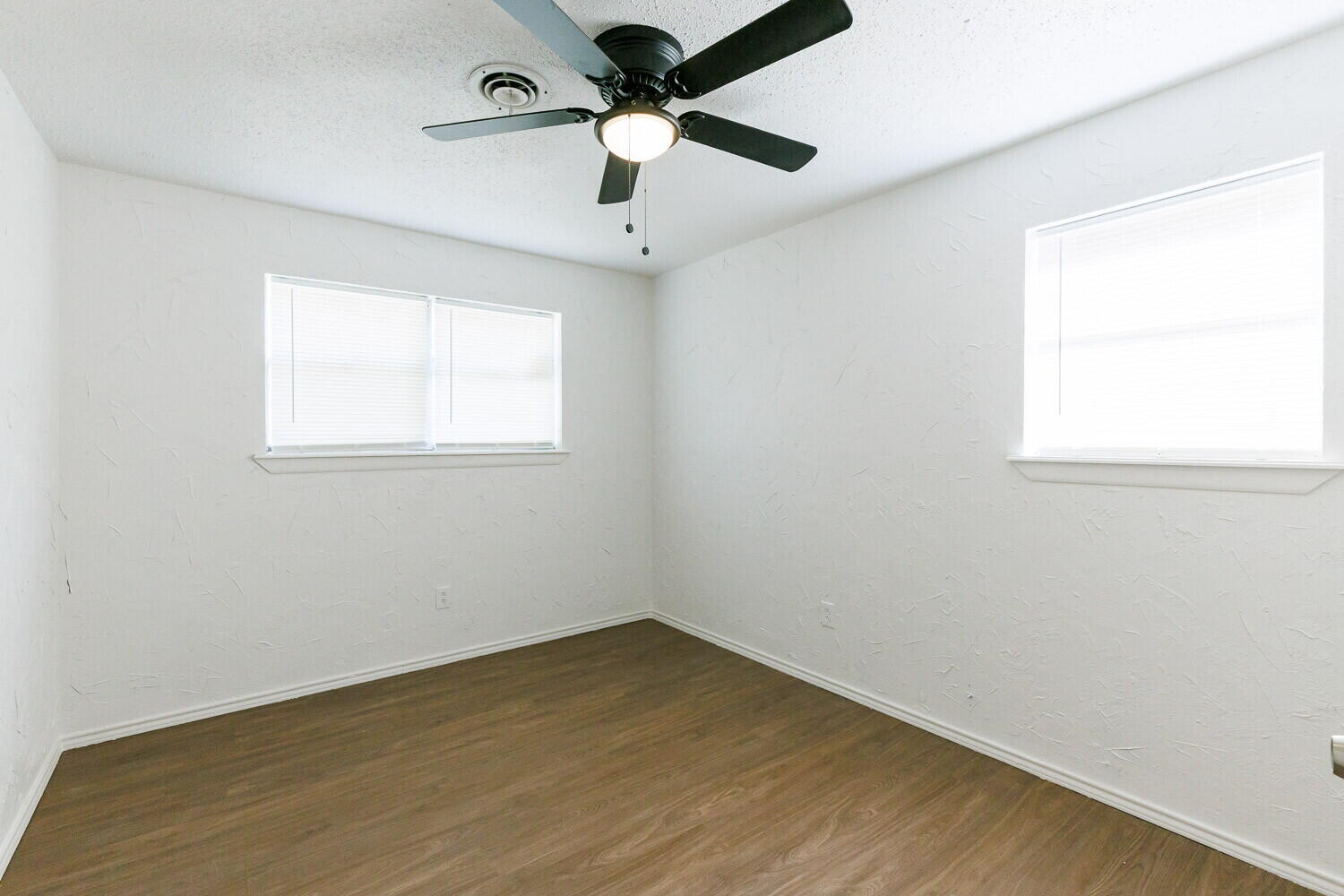 5517 16th Place Lubbock, TX 79416 - Photo 20 of 23 an empty room with a window and a fan