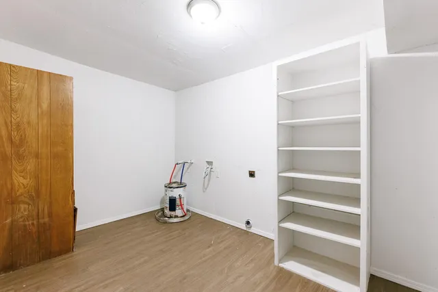 a view of room with wooden floor and closet