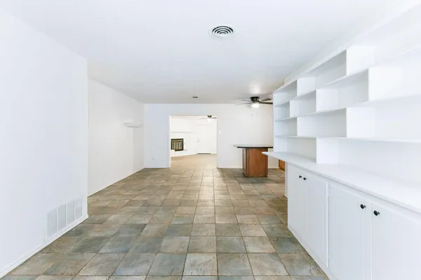 a view of a kitchen with a sink and a refrigerator